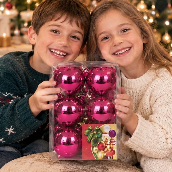 Dos niños felices enseñando a la cámara una caja de bolas navideñas fucsias de MegaSharkCo.